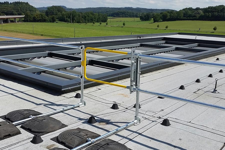 A Kee Gate self-closing safety gate installed on a rooftop
